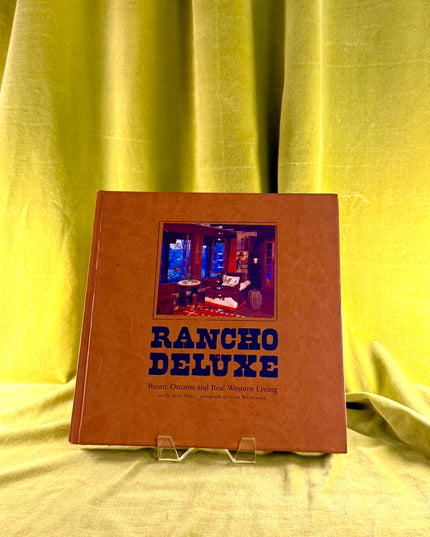 Book titled 'Rancho Deluxe' with a cover photo on a yellow fabric background
