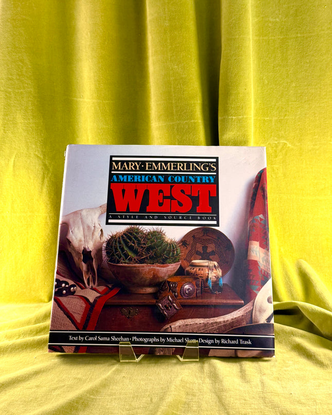 Book titled 'Mary Emmerling's American Country West' on a yellow fabric background