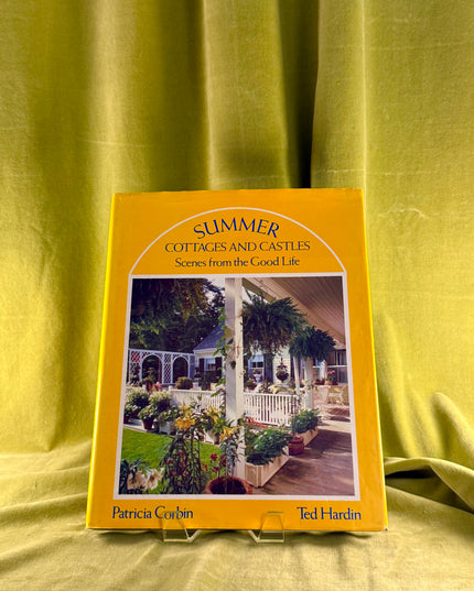 Book titled 'Summer Cottages and Castles' on a yellow fabric background