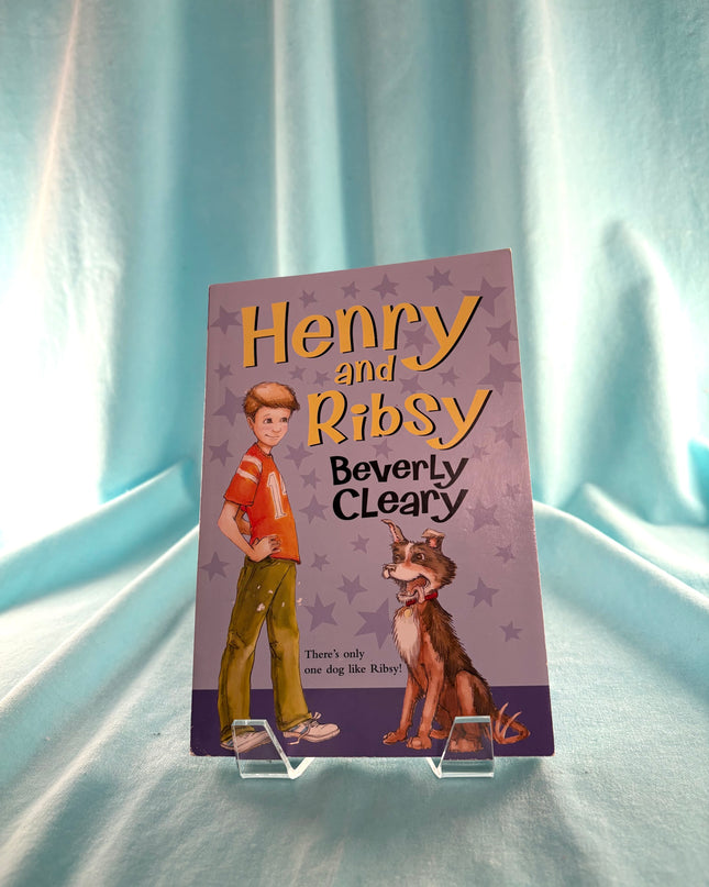 Book cover of 'Henry and Ribsy' by Beverly Cleary on a light blue curtain background