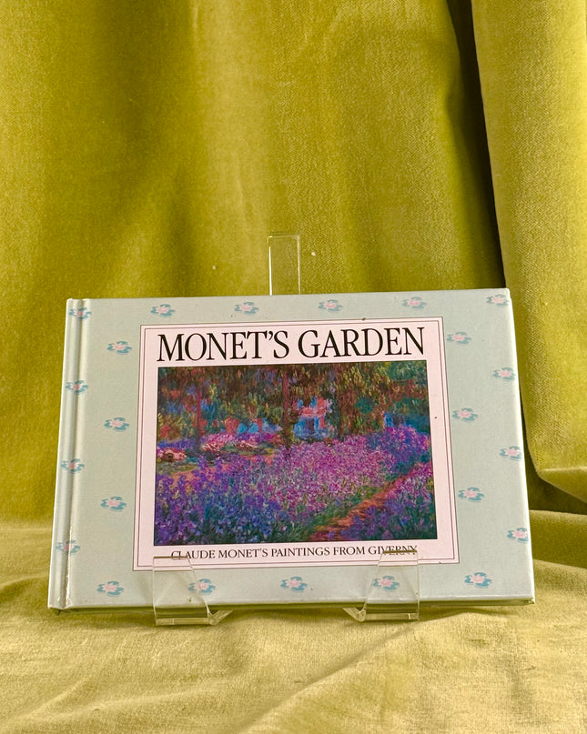 Book titled 'Monet's Garden' on a green fabric background