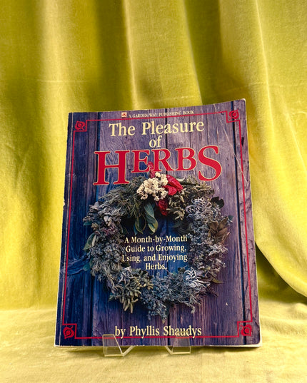 Book titled 'The Pleasure of Herbs' on a yellow background