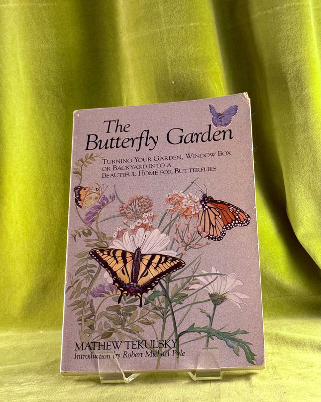 Book titled 'The Butterfly Garden' by Mathew Tekulsky on a green fabric background