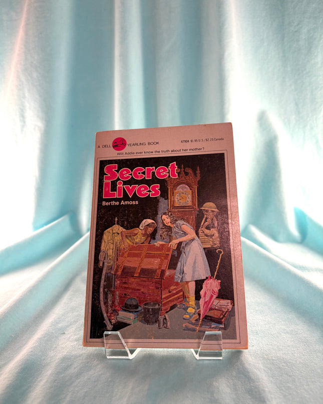 Vintage book titled 'Secret Lives' on a light blue curtain background