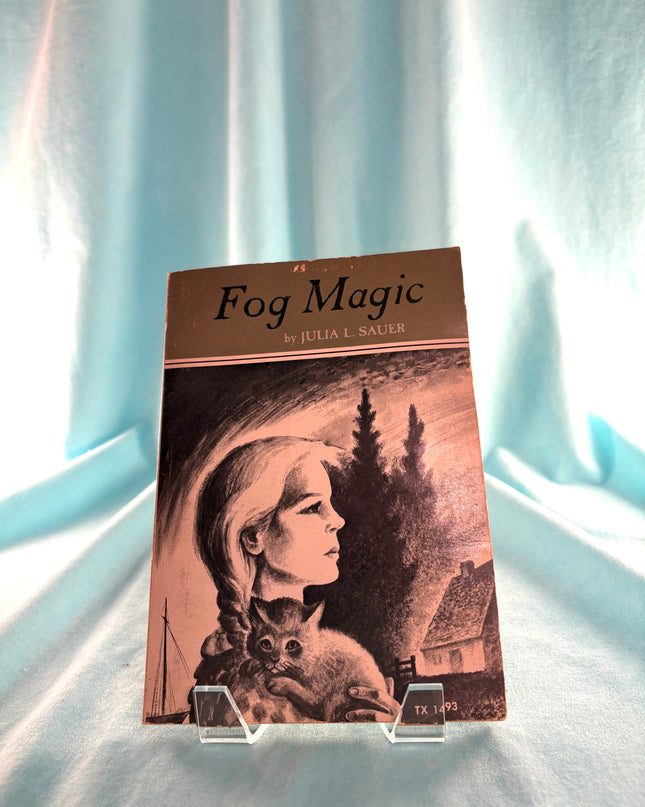 Book titled 'Fog Magic' by Julia A. Sailer on a light blue fabric background