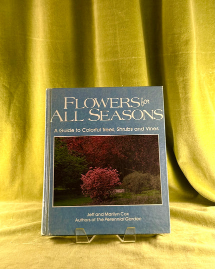 Book titled 'Flowers for All Seasons' on a yellow fabric background