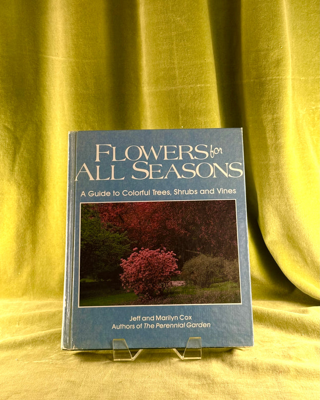 Book titled 'Flowers for All Seasons' on a yellow fabric background