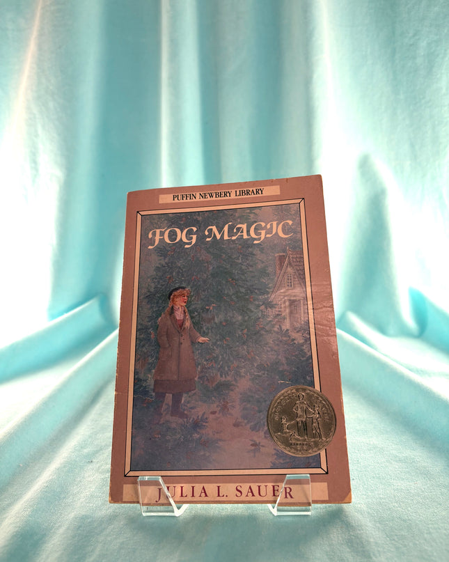 Book titled 'Fog Magic' by Julia L. Sauer on a light blue curtain background