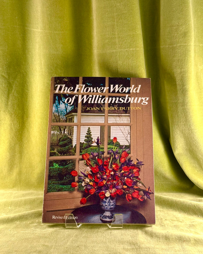 Book titled 'The Flower World of Williamsburg' on a green fabric background
