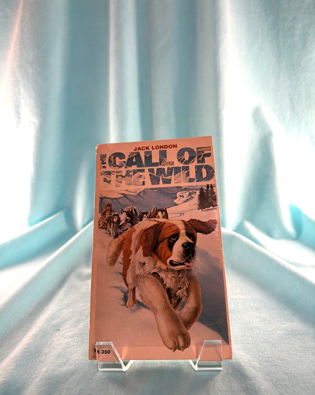 Book cover of 'Call of the Wild' by Jack London with a dog illustration on a light blue curtain background.