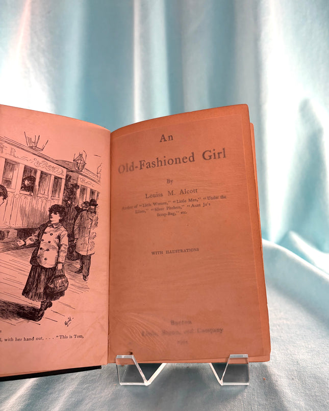 Open book titled 'An Old-Fashioned Girl' with illustrations on a light blue background