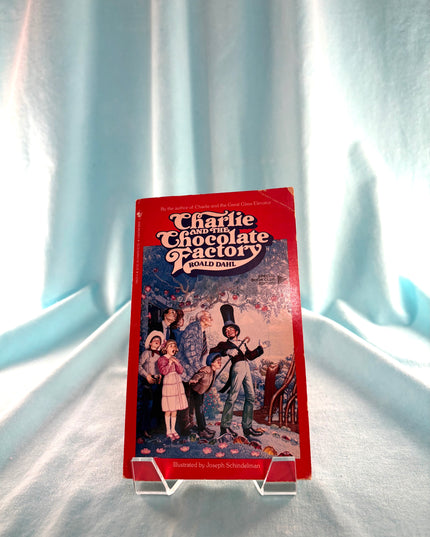 VHS tape of 'Charlie and the Chocolate Factory' on a light blue curtain background