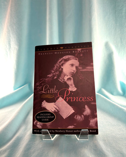 Book cover of 'Little Princess' by Frances Hodgson Burnett on a stand against a light curtain background