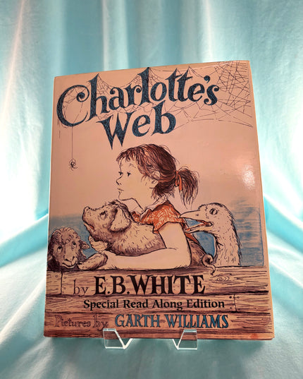 Book cover of 'Charlotte's Web' by E.B. White with illustrations on a light blue background