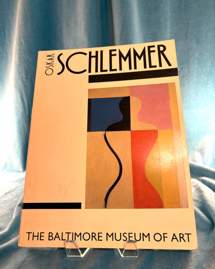 Poster for Oskar Schlemmer exhibition at The Baltimore Museum of Art on a blue fabric background