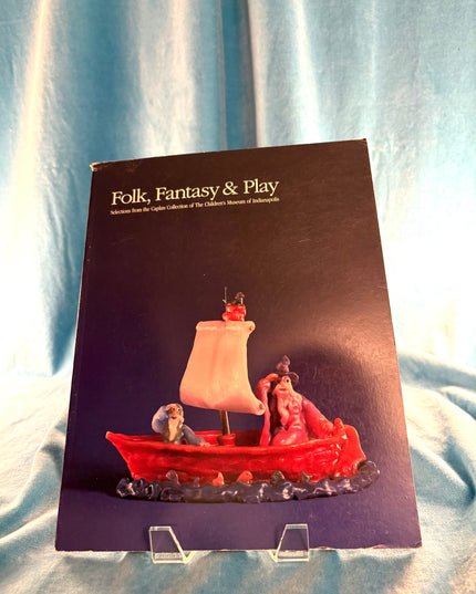 Book titled 'Folk, Fantasy & Play' with a cover illustration of a red boat on a white background.