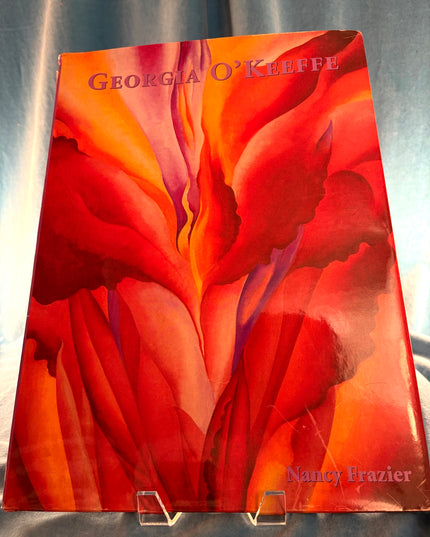 Book cover with red floral design and 'Georgia O'Keeffe' text on a gray background