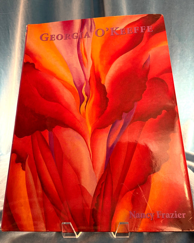Book cover with red floral design and 'Georgia O'Keeffe' text on a gray background