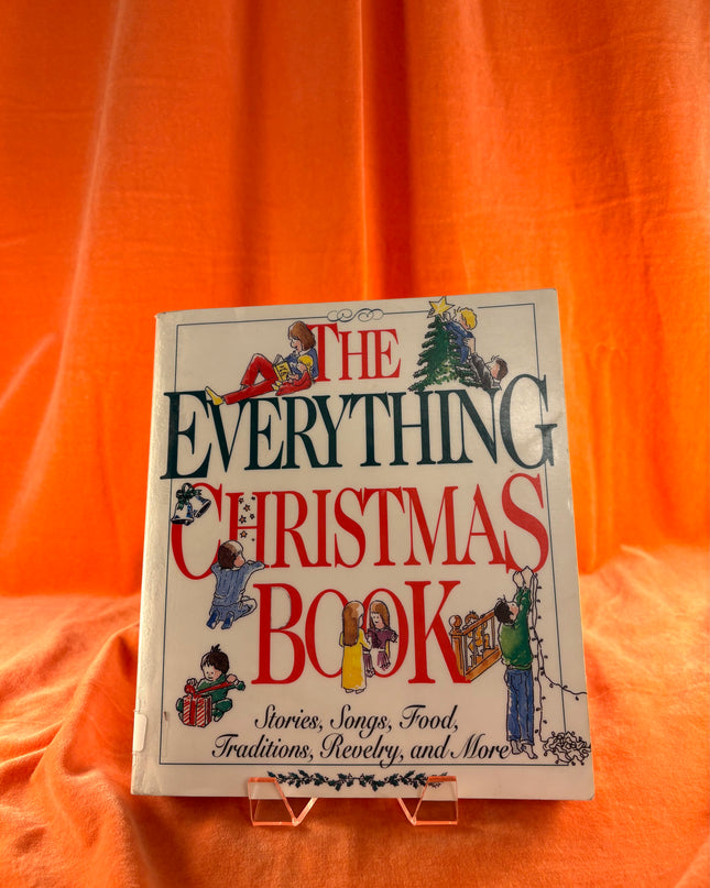 Book titled 'The Everything Christmas Book' on an orange fabric background