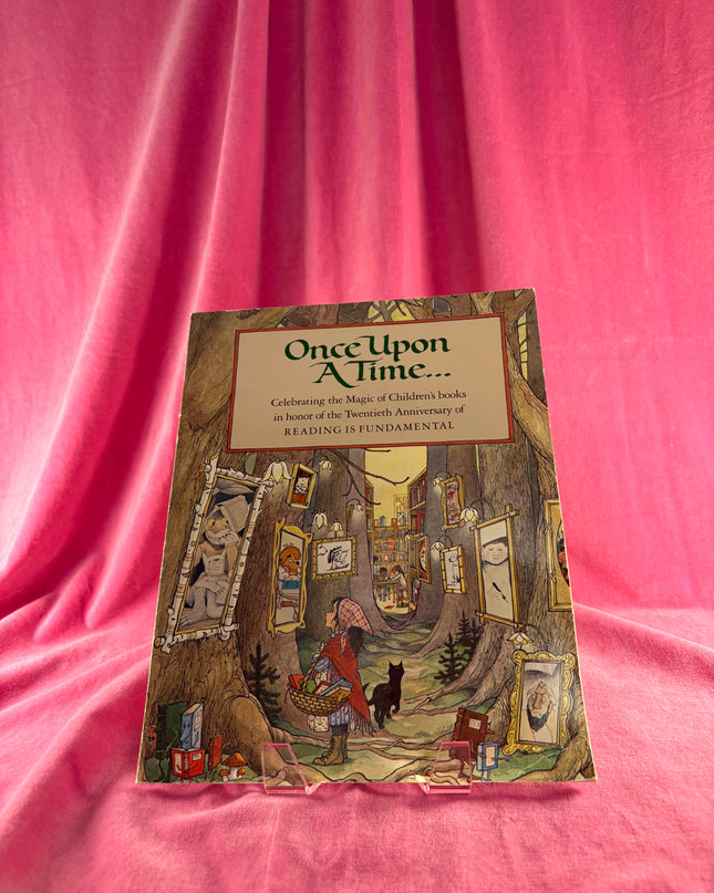 Book titled 'Once Upon A Time' on a pink fabric background