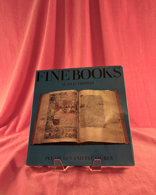 Book titled 'Fine Books' by Alan G. Thomas on a pink fabric background