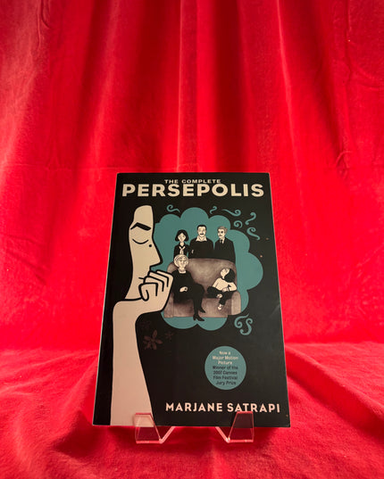 Book titled 'The Complete Persepolis' by Marjane Satrapi on a red background
