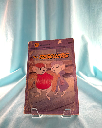 Vintage 'The Rescuers' book on a light blue background